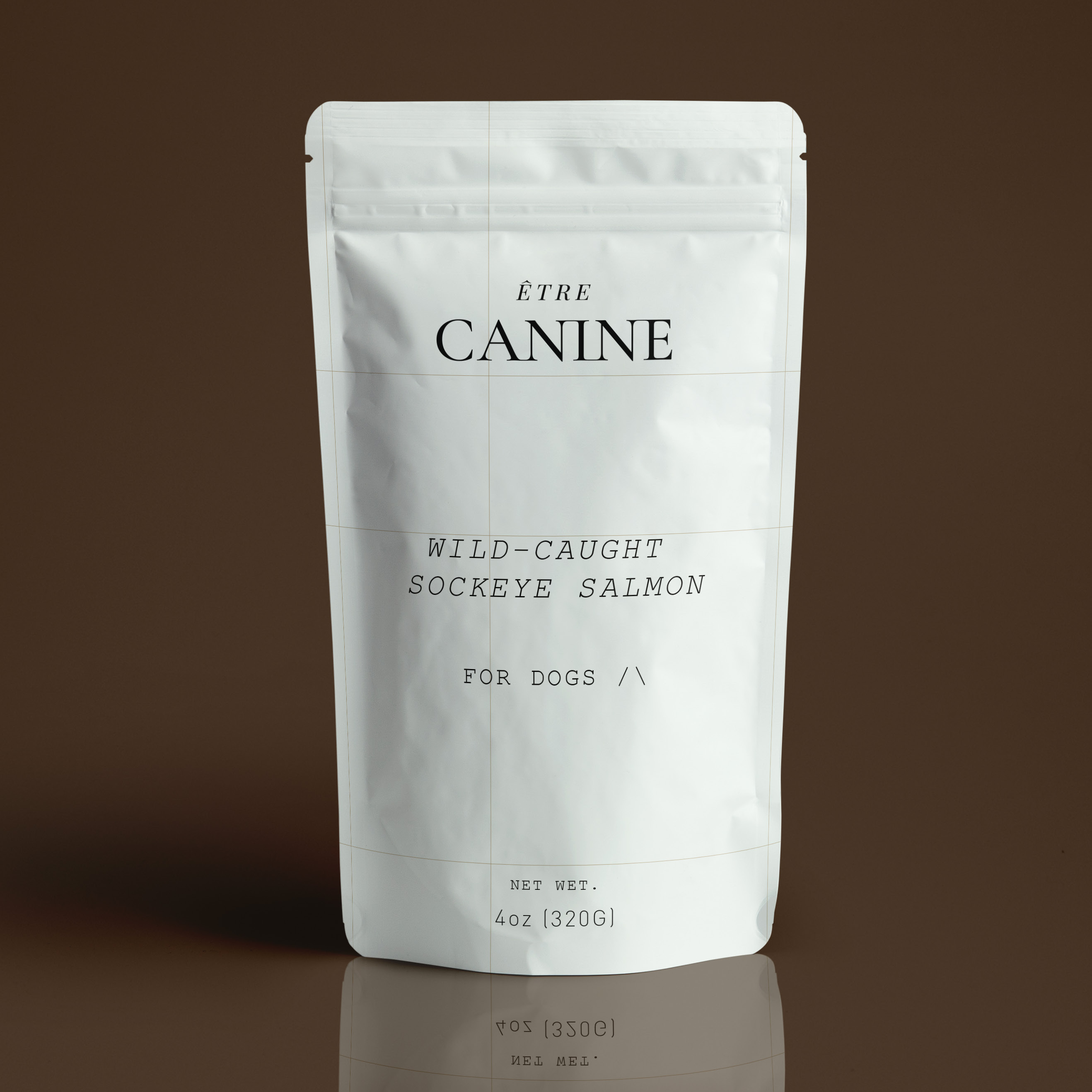White pet food package labeled 'ETRE CANINE' on a brown background